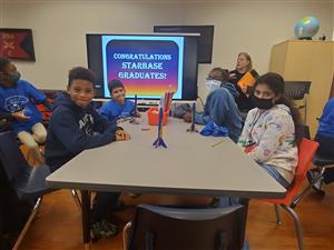 students at table with stomp rockets