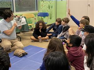students looking at turtle