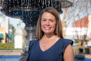 Dr. Tricia Patterson in front of fountain at Marietta Square