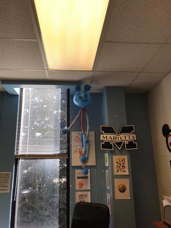 Amazing World of Gumball character themed balloon sculpture on classroom wall
