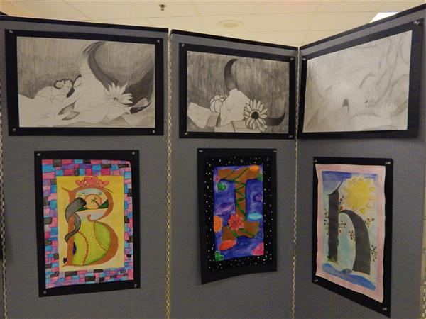 Student artwork of stylized letters and still-lifes of bull skull theme