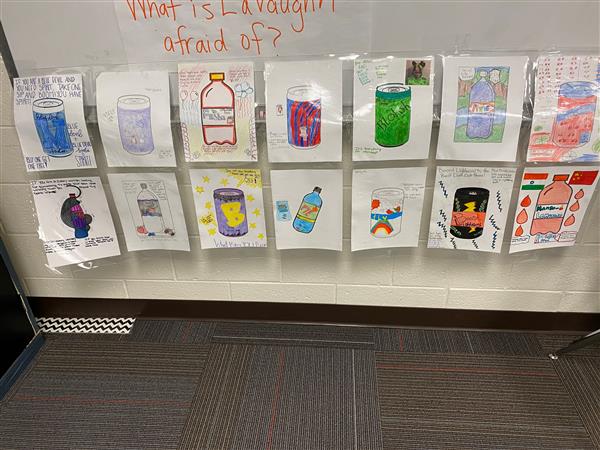 Student art display of drink cans and bottles drawn and colored on paper