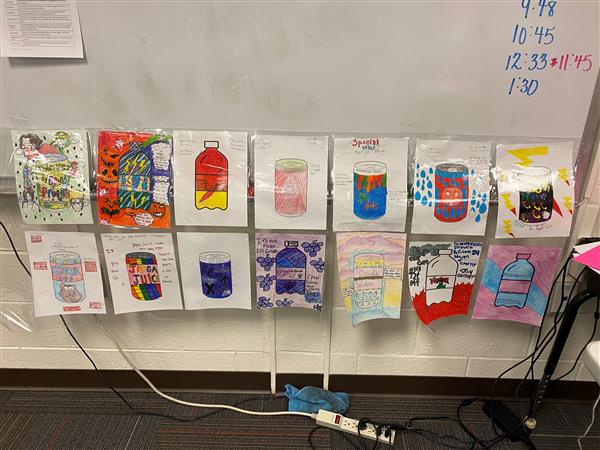 An additional student art display of drink cans and bottles drawn and colored on paper