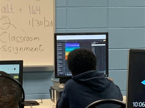 Student in front of computer monitor in classroom