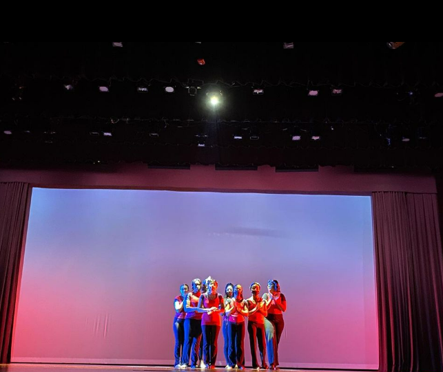 Student dancers grouped on stage during performance