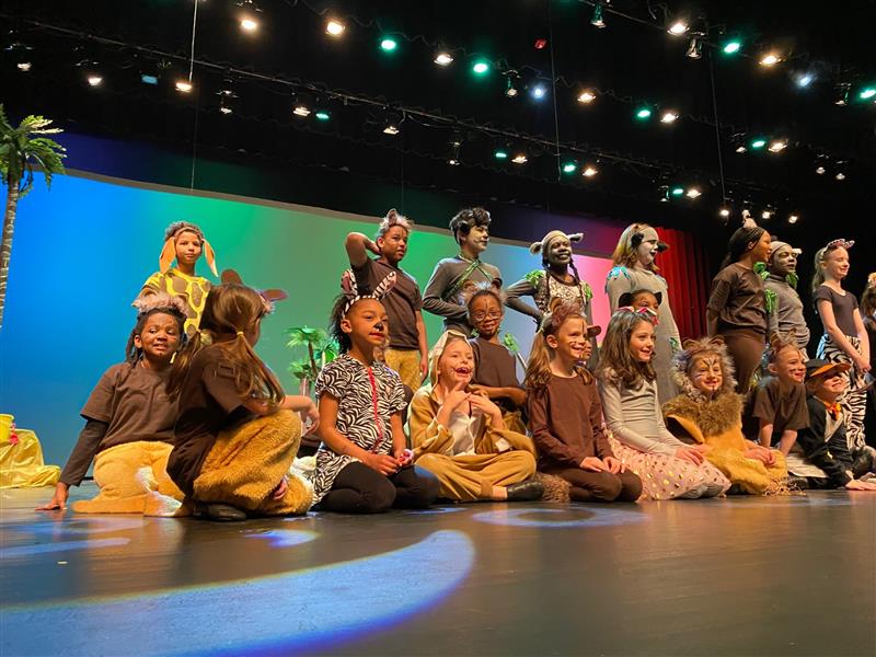 Students performing Madagascar dressed in a variety of animal costumes