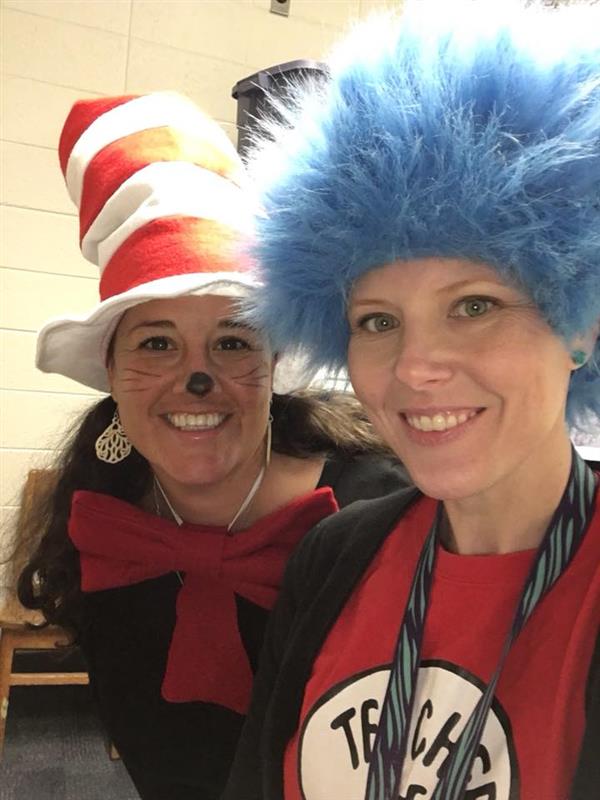 Two teachers in costume, one dressed as The Cat in the Hat and the other as Thing Two from Dr. Seuss' The Cat in the Hat story