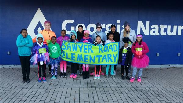 Girls on the Run team bundled up in coats for a chilly Atlanta 5K race