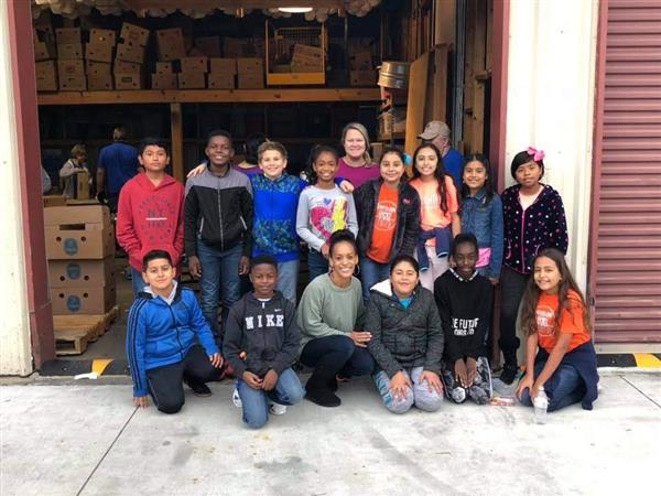 IB Student Ambassadors posing together after volunteering at a local food bank