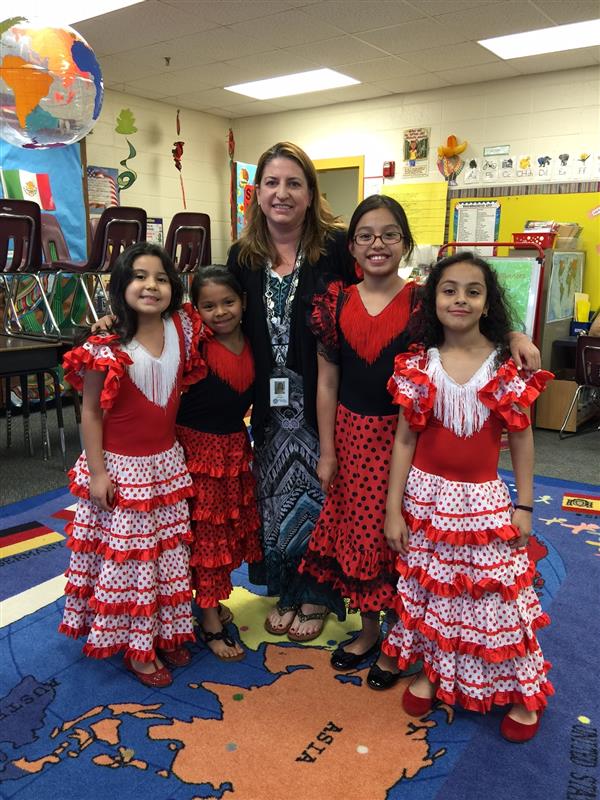 Spanish club students pose in traditional cultural dresses